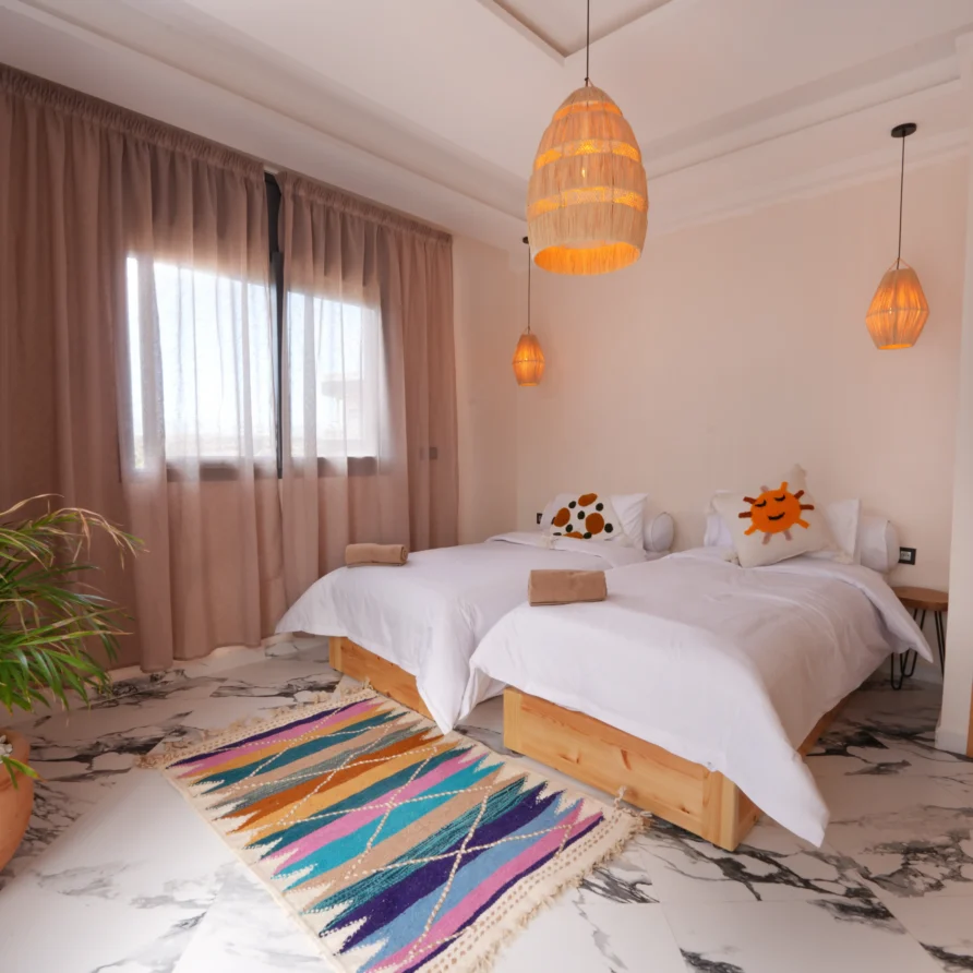 Complete view of beds, rug, lighting, and decor