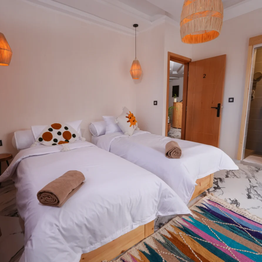 Decorative pillows on bed in Imsouane hotel room
