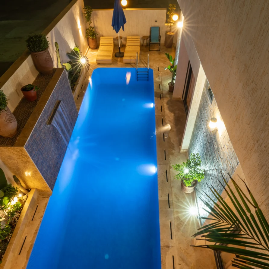Night view of illuminated pool and building