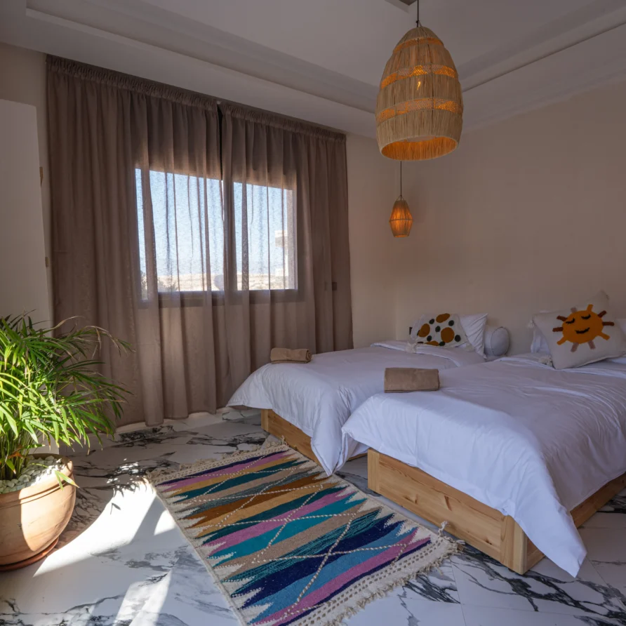 Room interior with marble floor and hanging lights in Imsouane hotel
