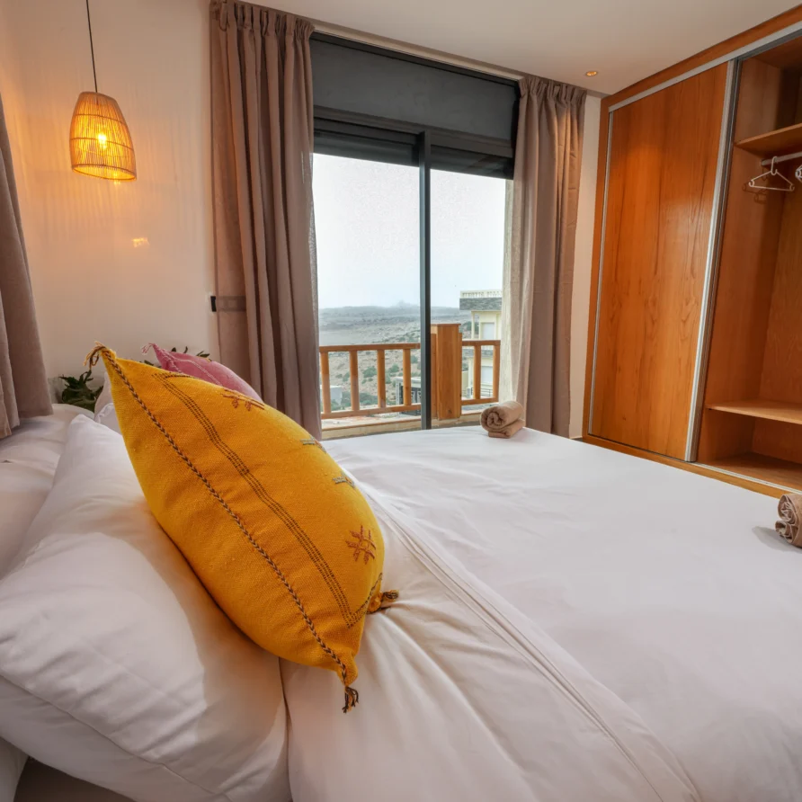 Imsouane surf camp room with warm lighting and boho decor
