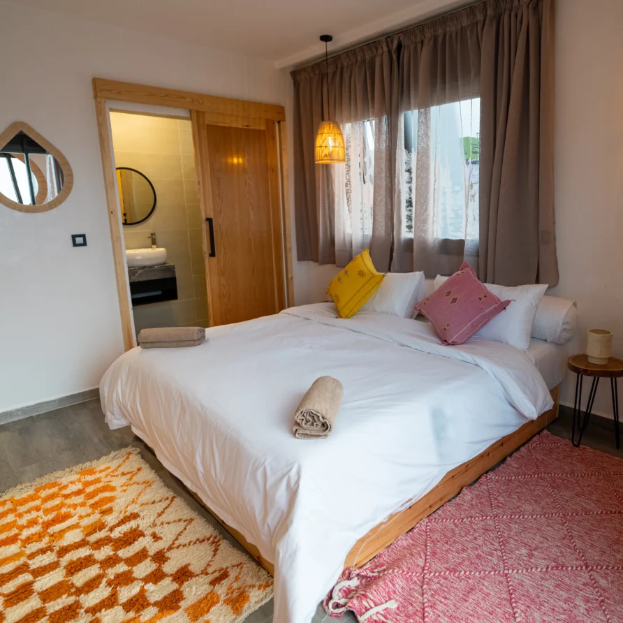 Deluxe double room in Imsouane surf hostel with warm decor