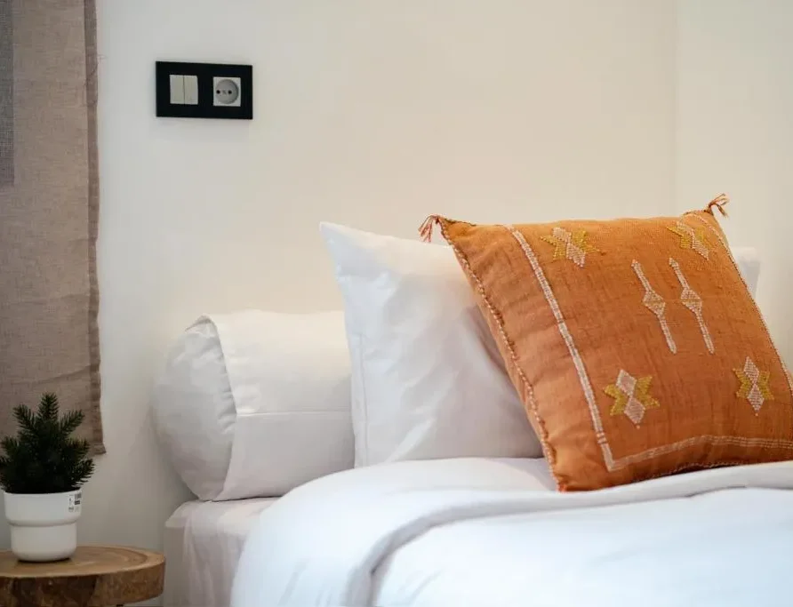pillow in side of bed cathedral residence imsouane surf camp.