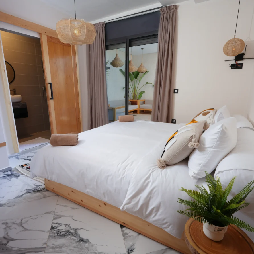 Wide view of Deluxe Double Room with extra-long bed at Residence Imsouane Surf Camp.