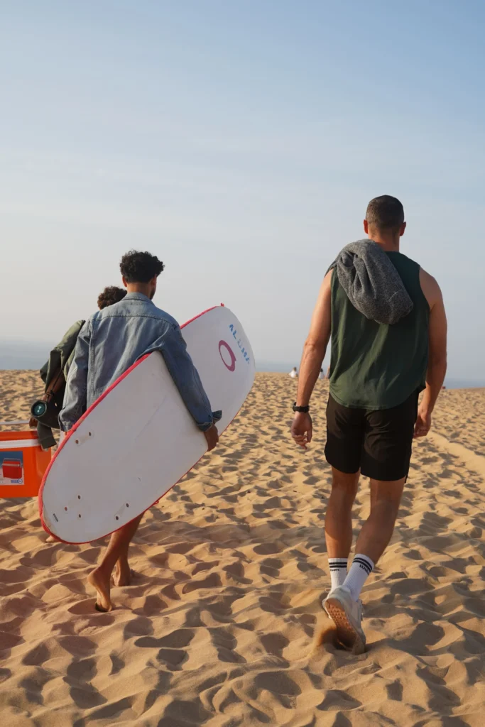 ayoub in with surfer in imsouane enjoying sand with residence imsouane surf camp